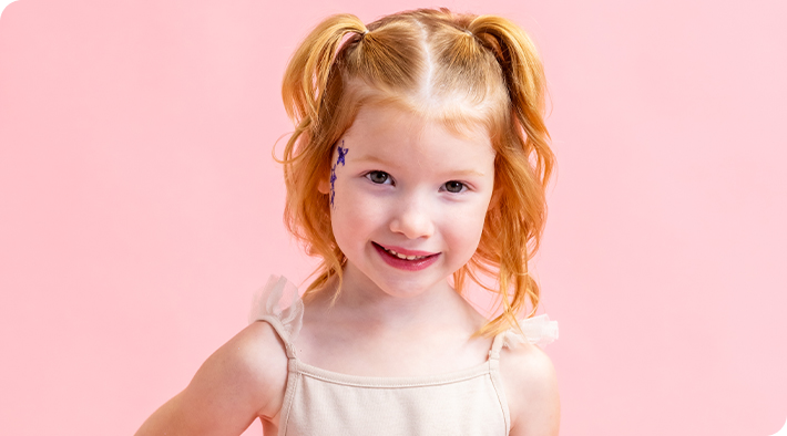 A girl smiling.