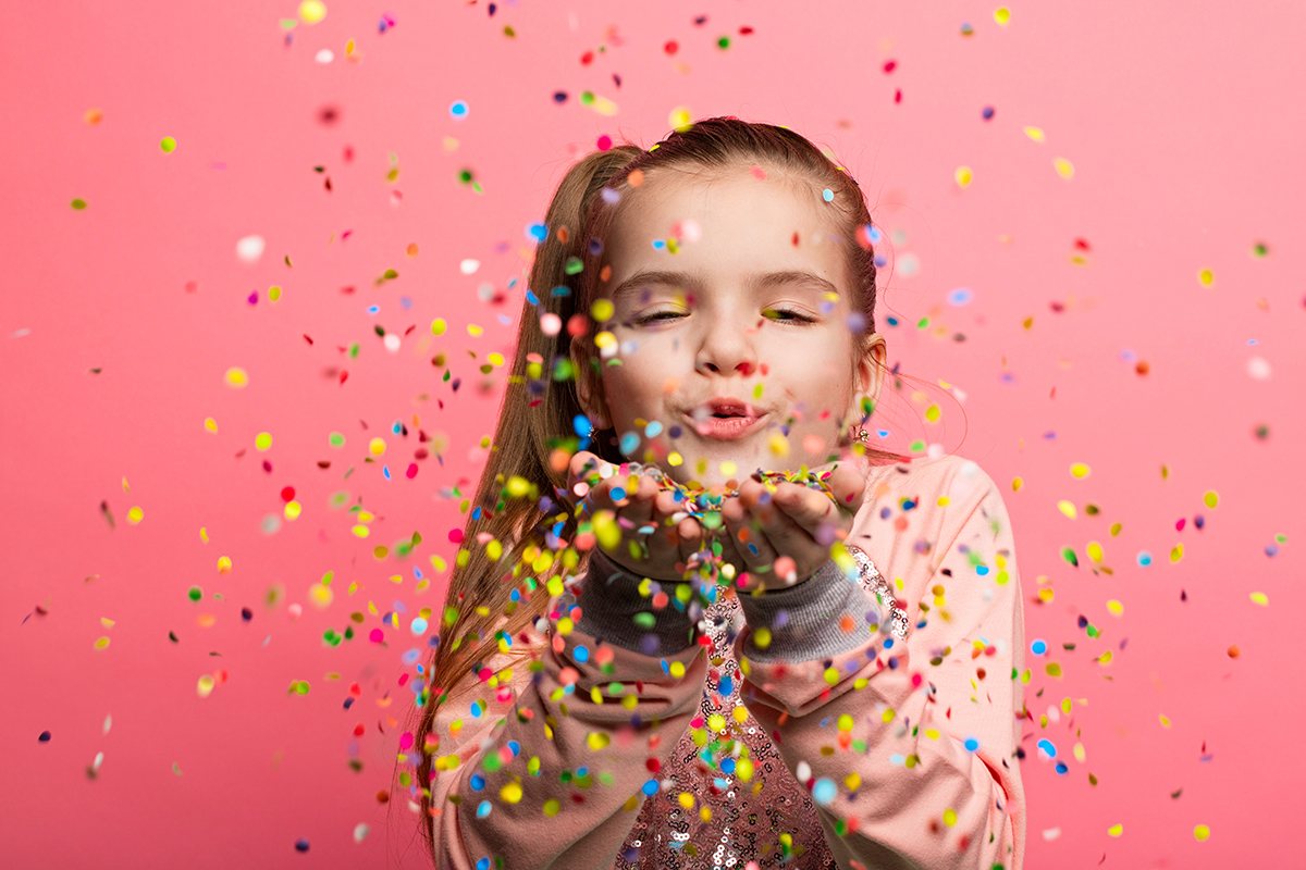 Little Girl blowing Confetti